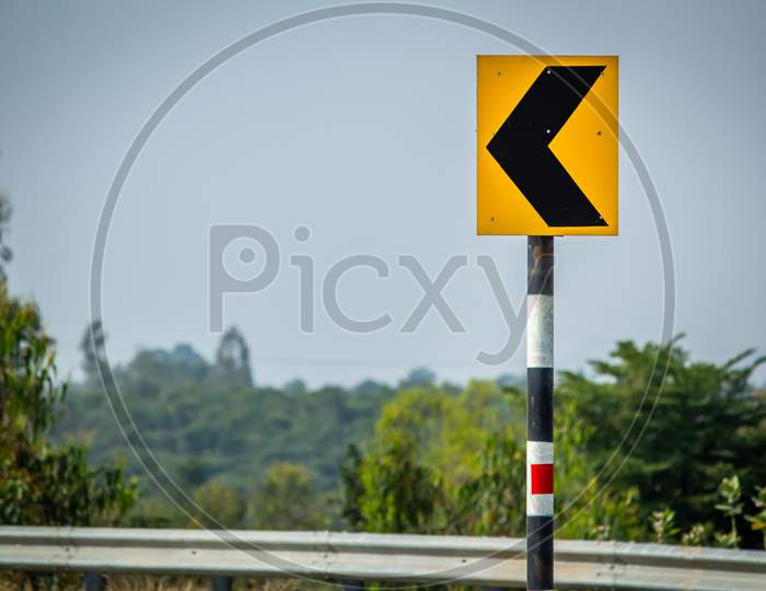 View Of The Road Sign Indicating A Curvy Road Ahead