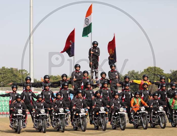 A Jammu and Kashmir policeman performs stunt on a motorcycle during the full dress rehearsal for the Republic Day celebrations, in Jammu, Sunday, Jan. 24, 2021.