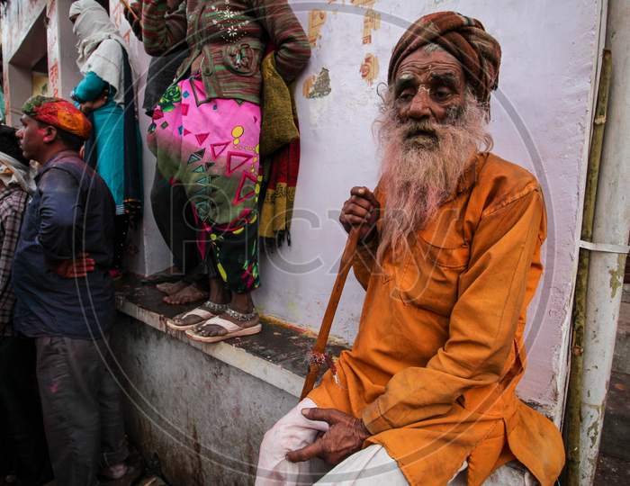 Mathura, Uttar Pradesh, India- January 6 2020: Portrait Of A Shant Sadhu Old Man, Sitting On A Rock Captured In Mathura During The Festival Of Holi.