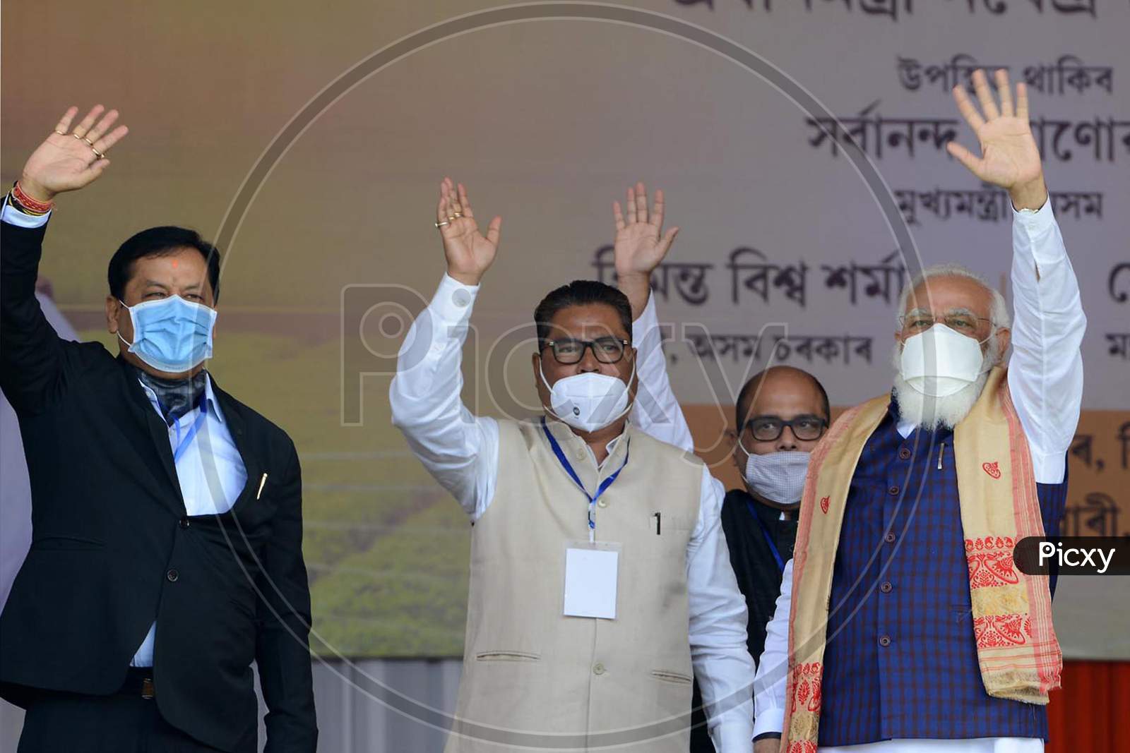 Prime Minister Narendra Modi with Assam CM Sarabananda Sonowal during a public meeting, at Jerenga Pathar in Sivasagar District of Assam, India  on Jan 23,2021