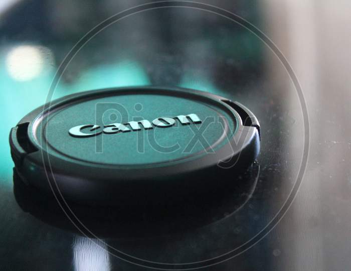 Canon camera lens cap close up view. Canon