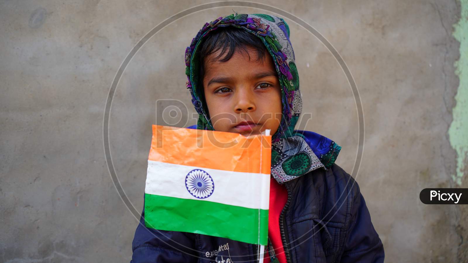 Cute Little Kid Holding The National Flag Of India. National Flag Or Tringa Closeup View On 72 Republic Day 2021.