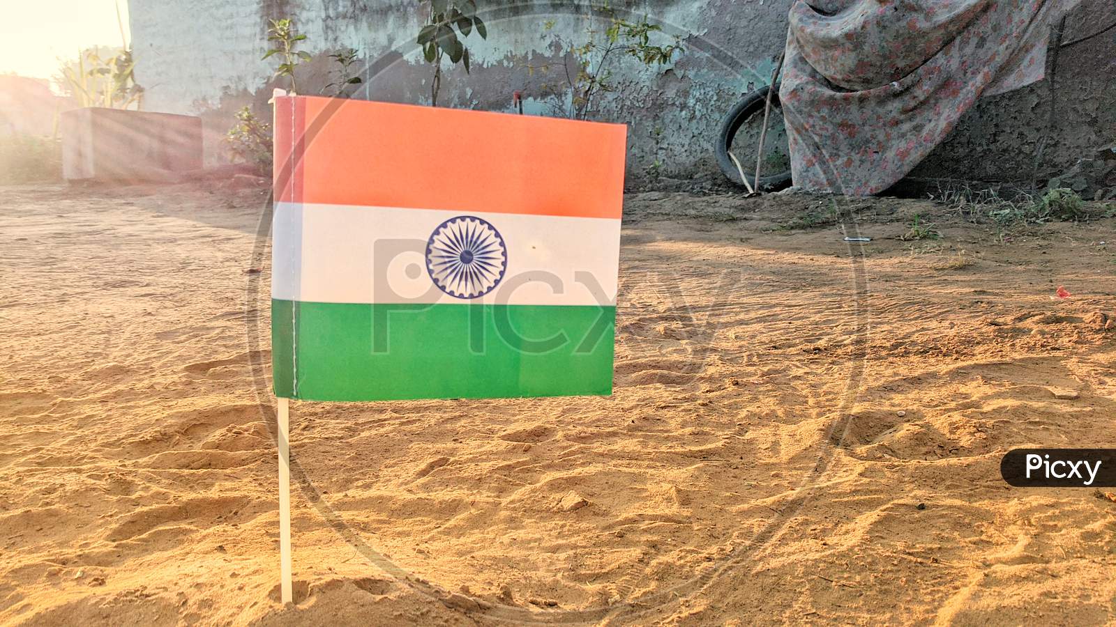 Official Flag Of Indian Government Closeup View With Plastic Flagpole Standing On The Ground. Tricolor Flag Or Tringa View.