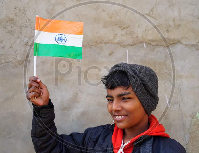 Cute Boy Pay Respect To Lift Out The Tringa Or National Flag To Lift Up High In Hand. 72 Th Republic Day Special.