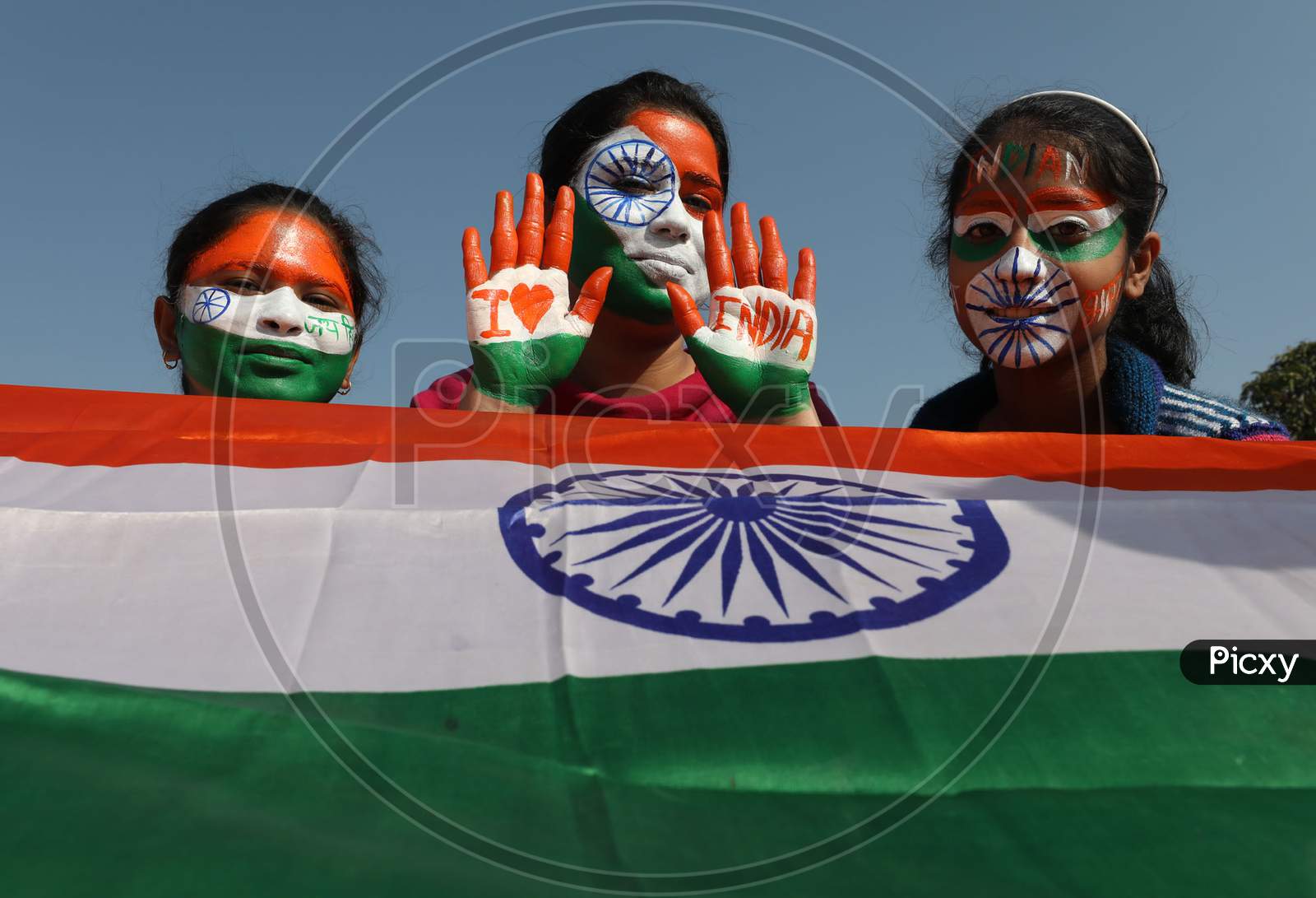 Girls with her face and hand painted in Tricolor poses for photographs on the eve of 72nd Republic Day, in Jammu, Monday, Jan. 25, 2021.