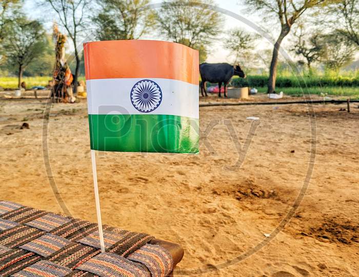 Waving Indian Flag With Flagpole And Ground Background. Beautiful Flag Standing On The Soil Ground. Victory Flag Closeup.
