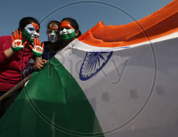 Girls with her face and hand painted in Tricolor poses for photographs on the eve of 72nd Republic Day, in Jammu, Monday, Jan. 25, 2021.