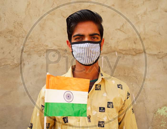 Swinging National Flag Of India. A Boy Showing Dignity Of Tringa Or Flag On The Ceremony Of 72 Th Republic Day.