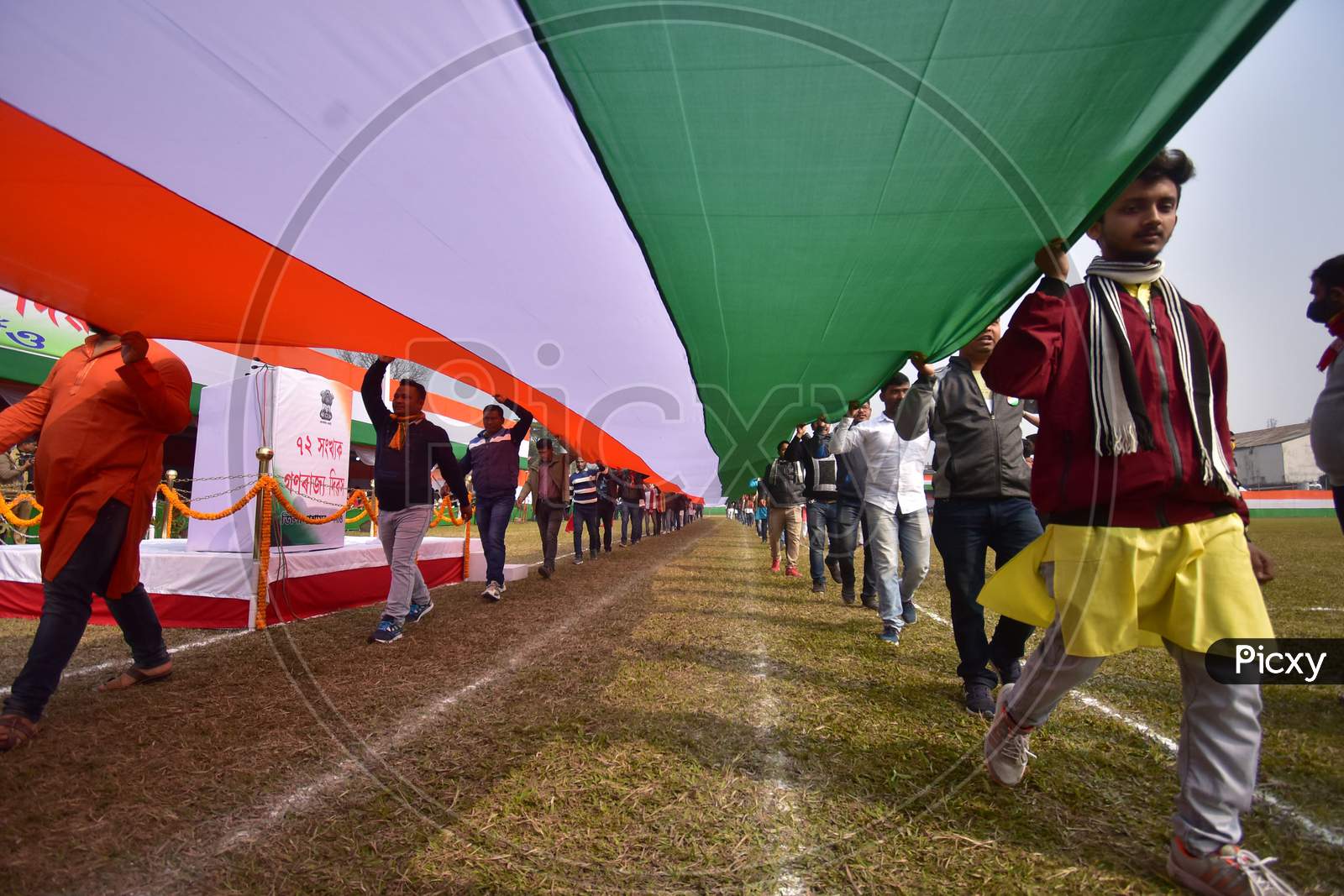 Youth  carry a 100ft long Tricolour  on the occasion of 72nd Republic Day at Nurul Amin stadium parade ground in  Assam on Jan 26,2021