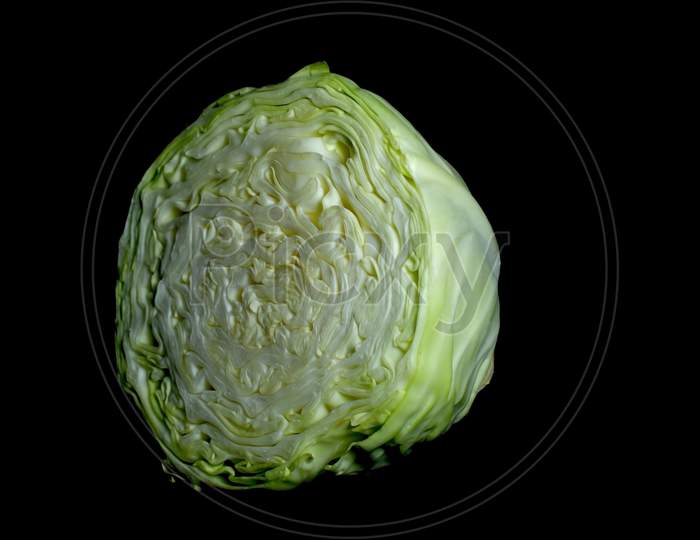 half cut cabbage with black background