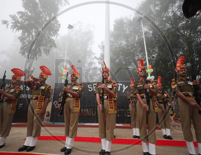 BSF soldiers salutes after hoisting the National Flag on the occasion of 72nd Republic Day celebrations at octroi post in Suchatgarh International border in Jammu ,26 Jan,2021.