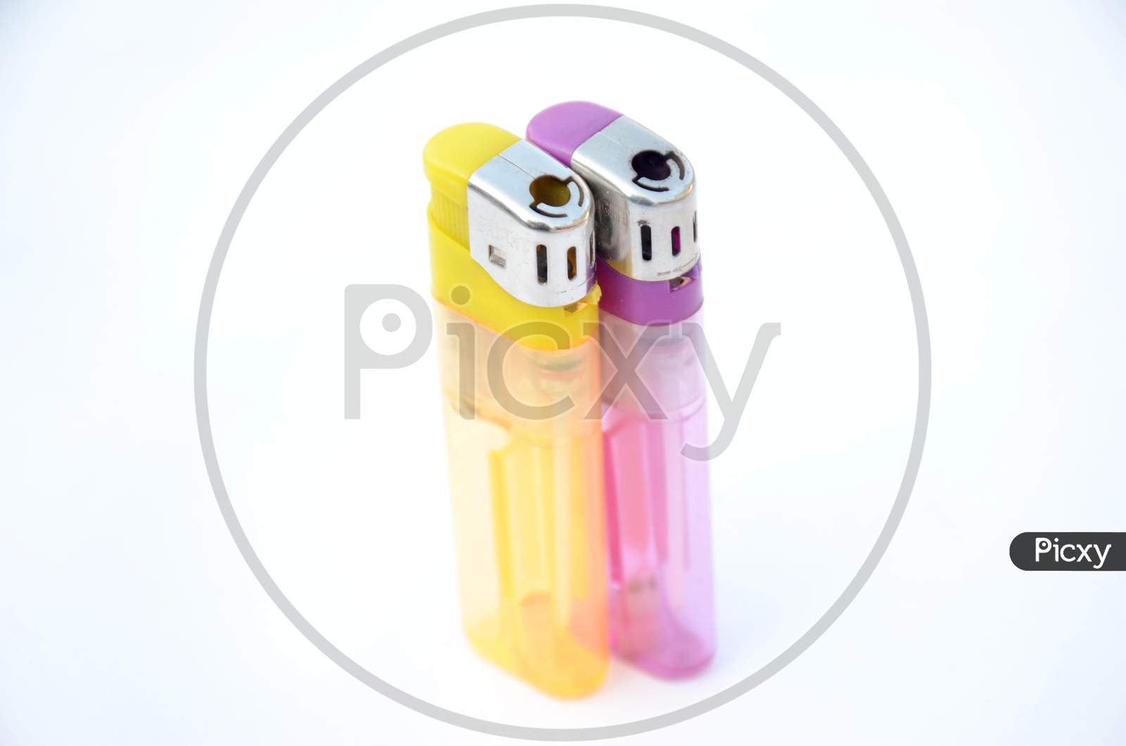 The Pair Of Yellow Purple Gas Lighter Isolated On White Background.