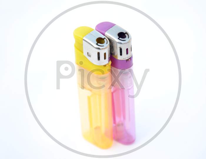 The Pair Of Yellow Purple Gas Lighter Isolated On White Background.