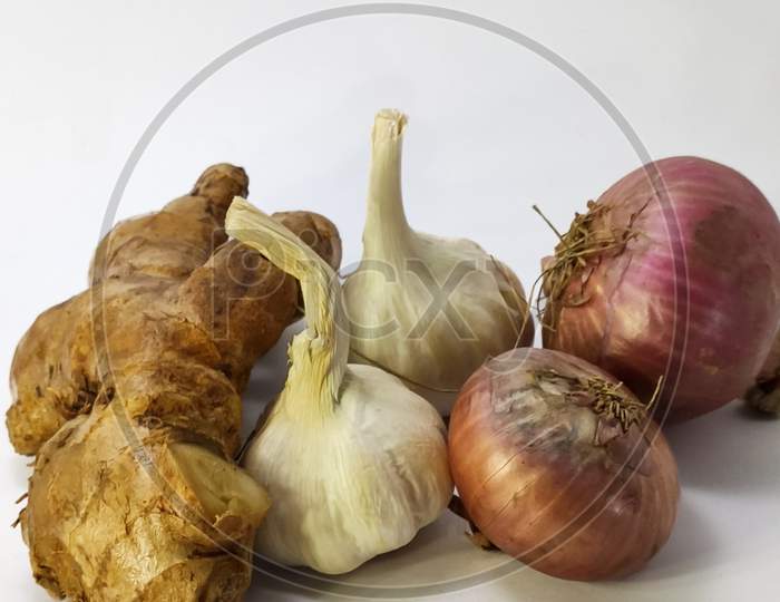 Fresh Garlic,Ginger And Onion On A White Isolated Surface