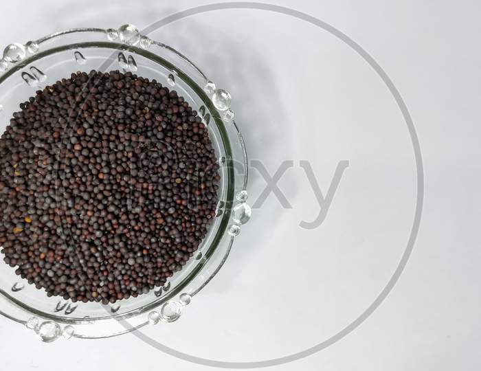 Mustard Seeds In Glass Bowl On A White Isolated Surface