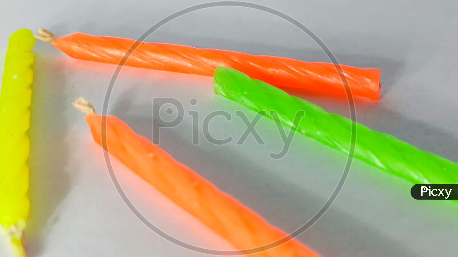 Colorful Wax Candles On A White Isolated Surface