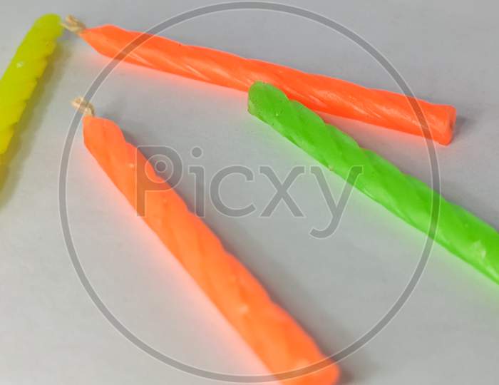 Colorful Wax Candles On A White Isolated Surface