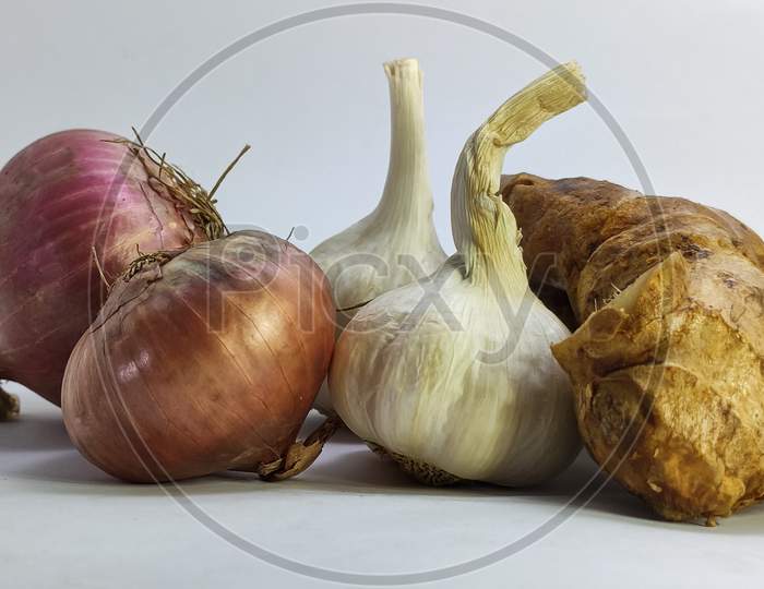 Fresh Garlic,Ginger And Onion On A White Isolated Surface