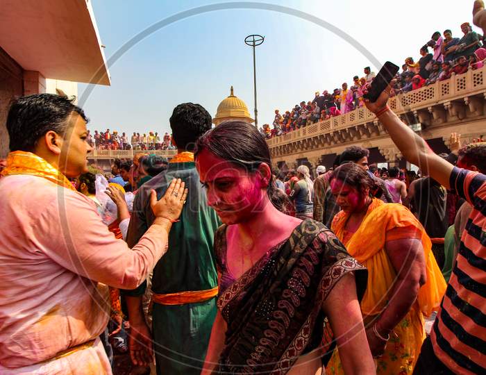 Mathura, Uttar Pradesh, India- January 28 2020: Young Man Peeing Down The Balcony In The Nandgaon Temple. People Enjoying And Playing With Colors While Celebrating The Festival Of Holi.