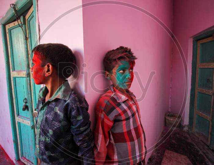 Mathura, Uttar Pradesh, India- January 28 2020: Two Kids Standing In Front Of A Pink Wall With Their Faces Covered In Colors, Enjoying During The Festival Of Holi In Mathura.