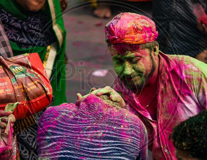 Mathura, Uttar Pradesh/ India- January 6 2020: An Unidentified Man With Face Fully Smeared With Red Color Looks As He Participates In The Holi Celebration At Krishna Temple Pose For Camera During Holi Festival.