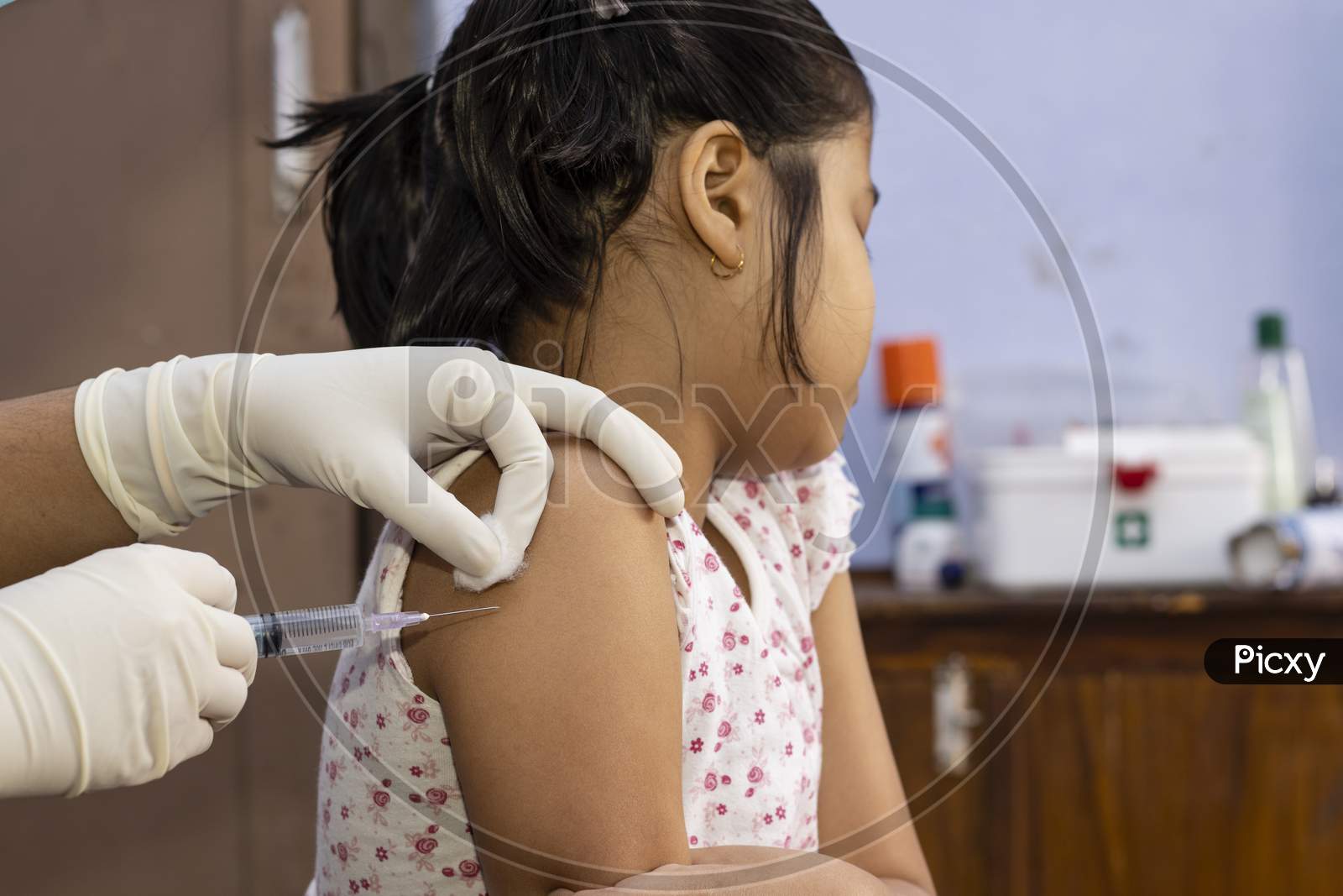 An Indian Girl Child Looking Away In Fear During Vaccination