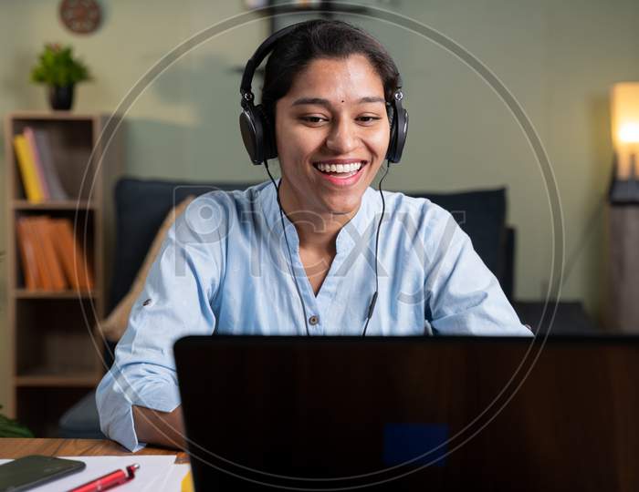 Happy Smiling Young Business Woman With Headphone In Video Call On Laptop Busy Talking - Concept Of Online Chat, Distance Webinar, Video Conference During Work From Home.