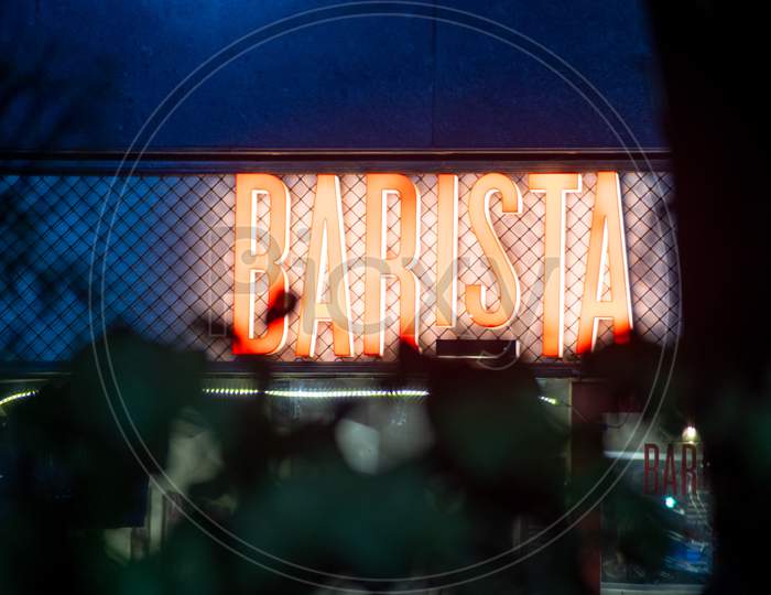 Lit Signboard Of Barista Coffee Shop Shot At Night Showing This All Night Shop As A Destination For Couples And People