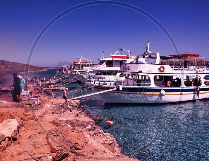 Crete Or Kreta, Greece - September 14, 2017: Three Ships Docked With Tourist And People Grilling On Mediterranean Sea Island Between Imeri Gramvousa To Cape Gramvousa, Kissamos