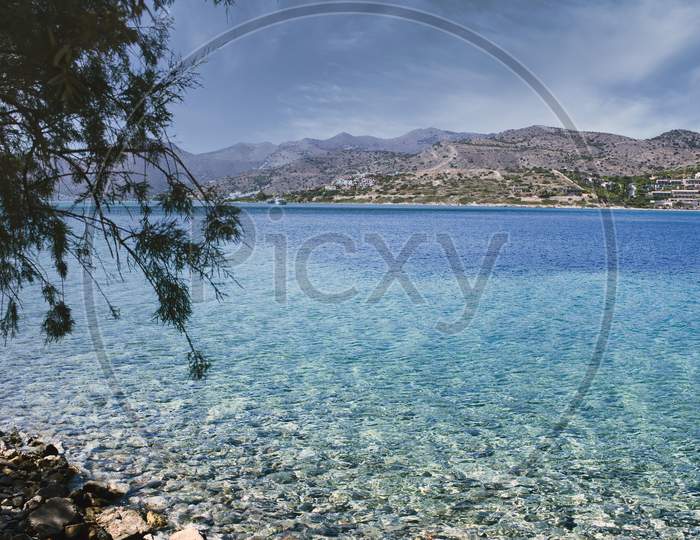 Crete Or Kreta, Greece: View Of The Mediterranean Sea Against Rocky Terrain On Spinalonga Island, Formerly Used As A Leper Colony, Near Elounda, Mirabello Gulf
