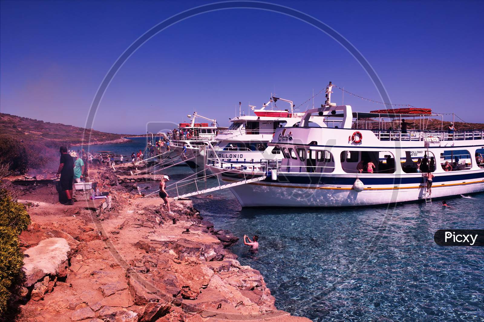 Crete Or Kreta, Greece - September 14, 2017: Three Ships Docked With Tourist And People Grilling On Mediterranean Sea Island Between Imeri Gramvousa To Cape Gramvousa, Kissamos