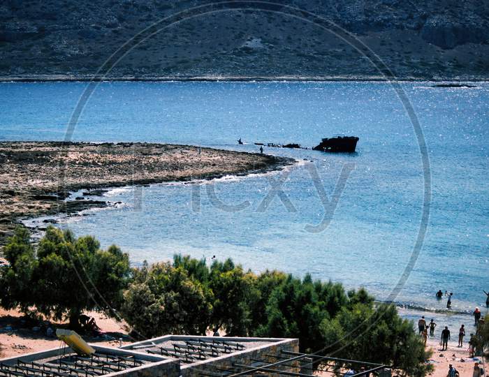 Rusty Shipwreck Off The Island Of Imeri Gramvousa, Crete, Greece On Mediterranean Sea During Summer