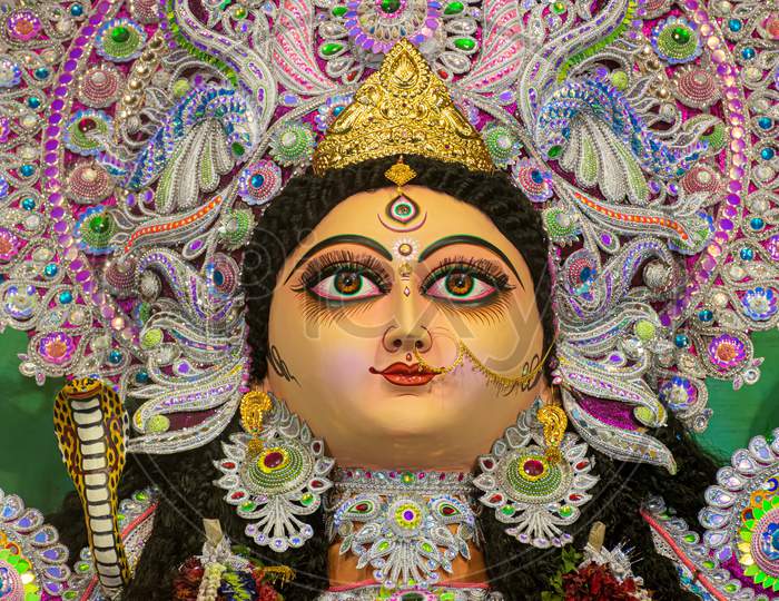 Picture Of Goddess Jagadhatri Idol Decorated Puja Pandal, Shot At Colored Light In West Bengal, India.