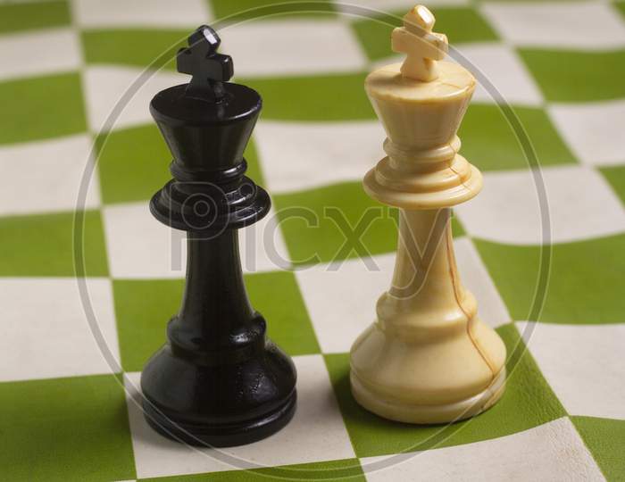 One Side Light On Black And White King Chess Piece. Close Up Photo