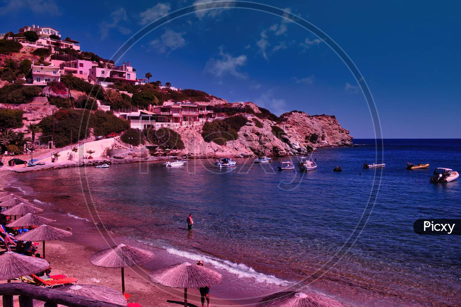 Crete Island, Greece: Wide Angle Cityscape Showing Blue Mediterranean Beach Near Heraklion City With Tourist During Summer