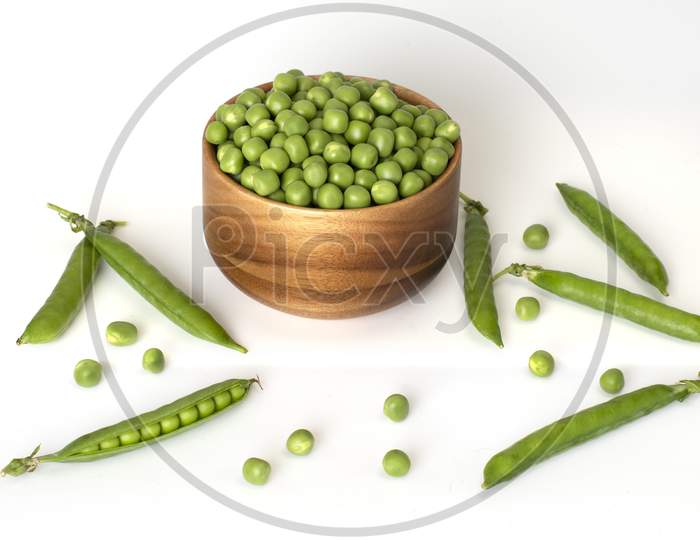 Bowl Of Green Peas And Some Pods