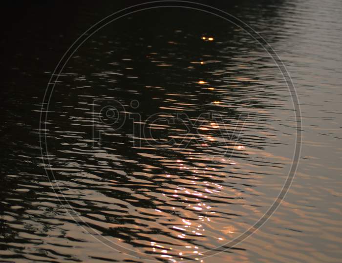 Sunset Reflection In Water Creates An Abstract Pattern