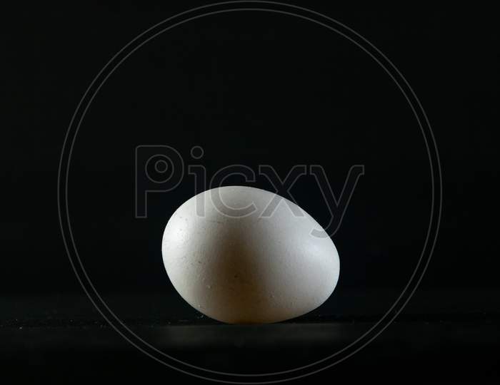 Chicken Egg On Black Background