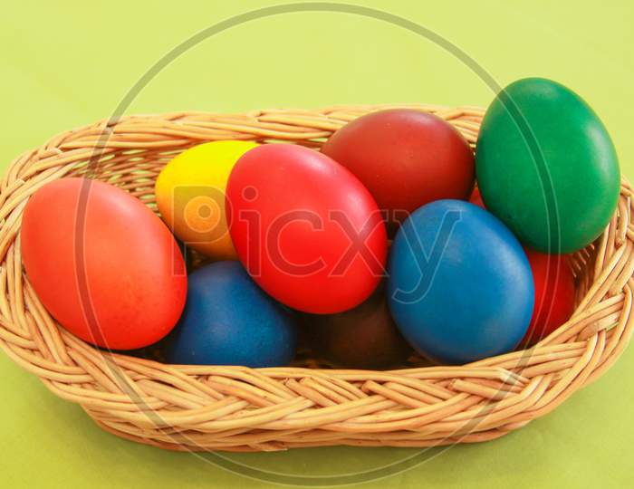 Easter Eggs Colors In Basket Green Background