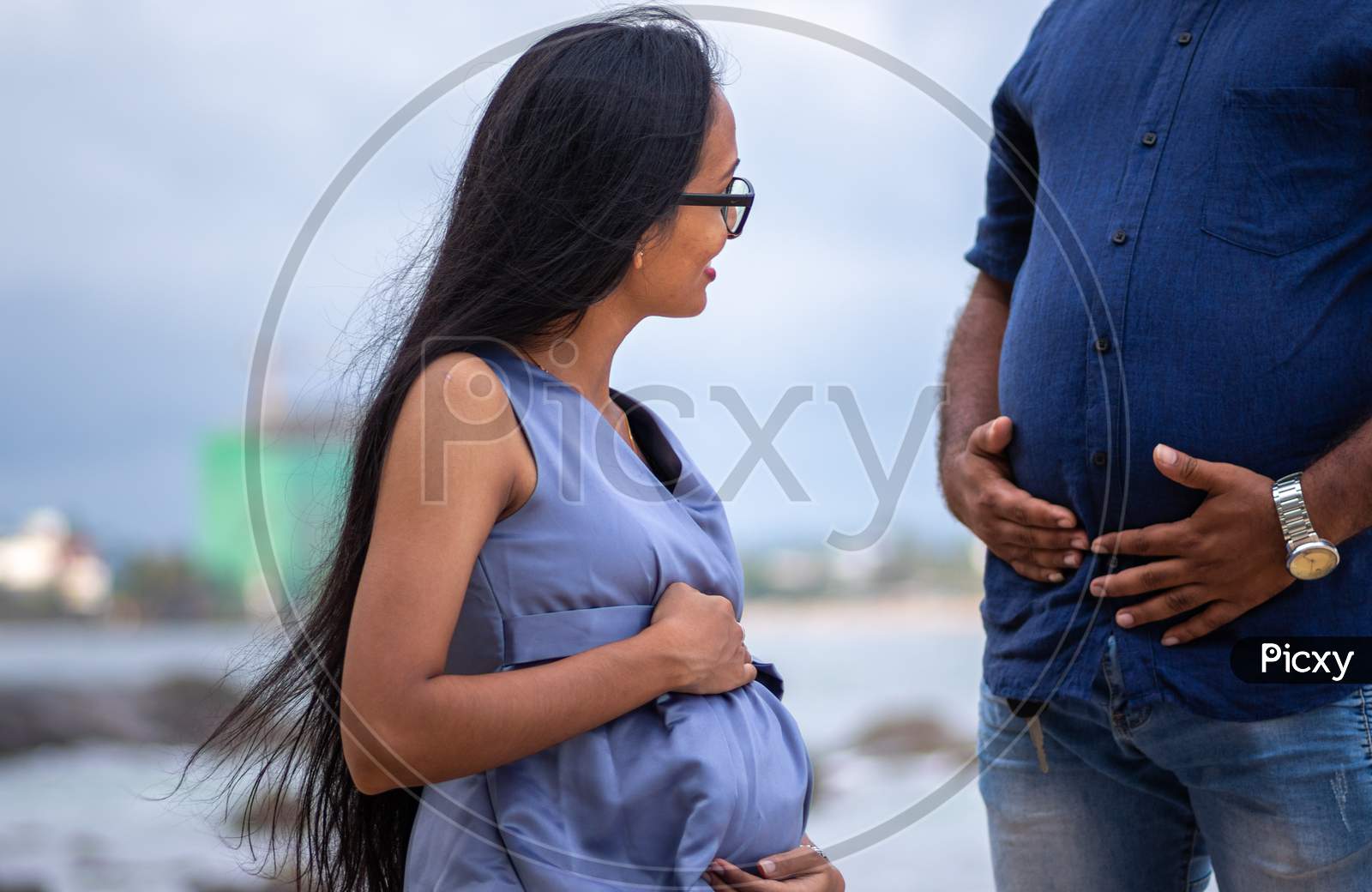 Pregnant woman on the beach. Adult lady on the beach about to give birth.  High risk