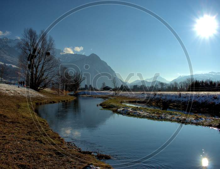Small River Flows Through The Nature In Vaduz In Liechtenstein 7.1.2021