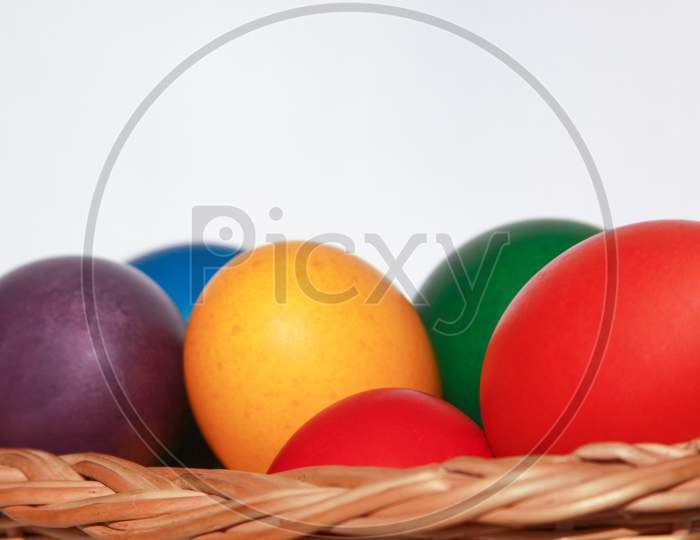 Easter Eggs Colors In Basket White Background
