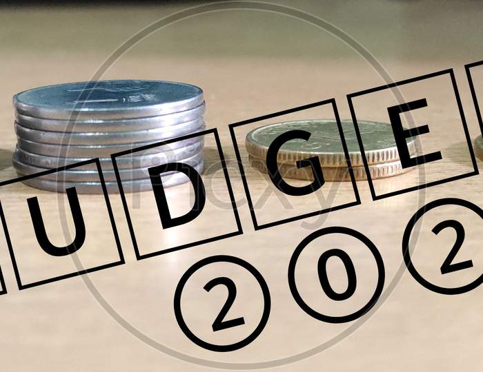Budget 2021 text word written with coins background,