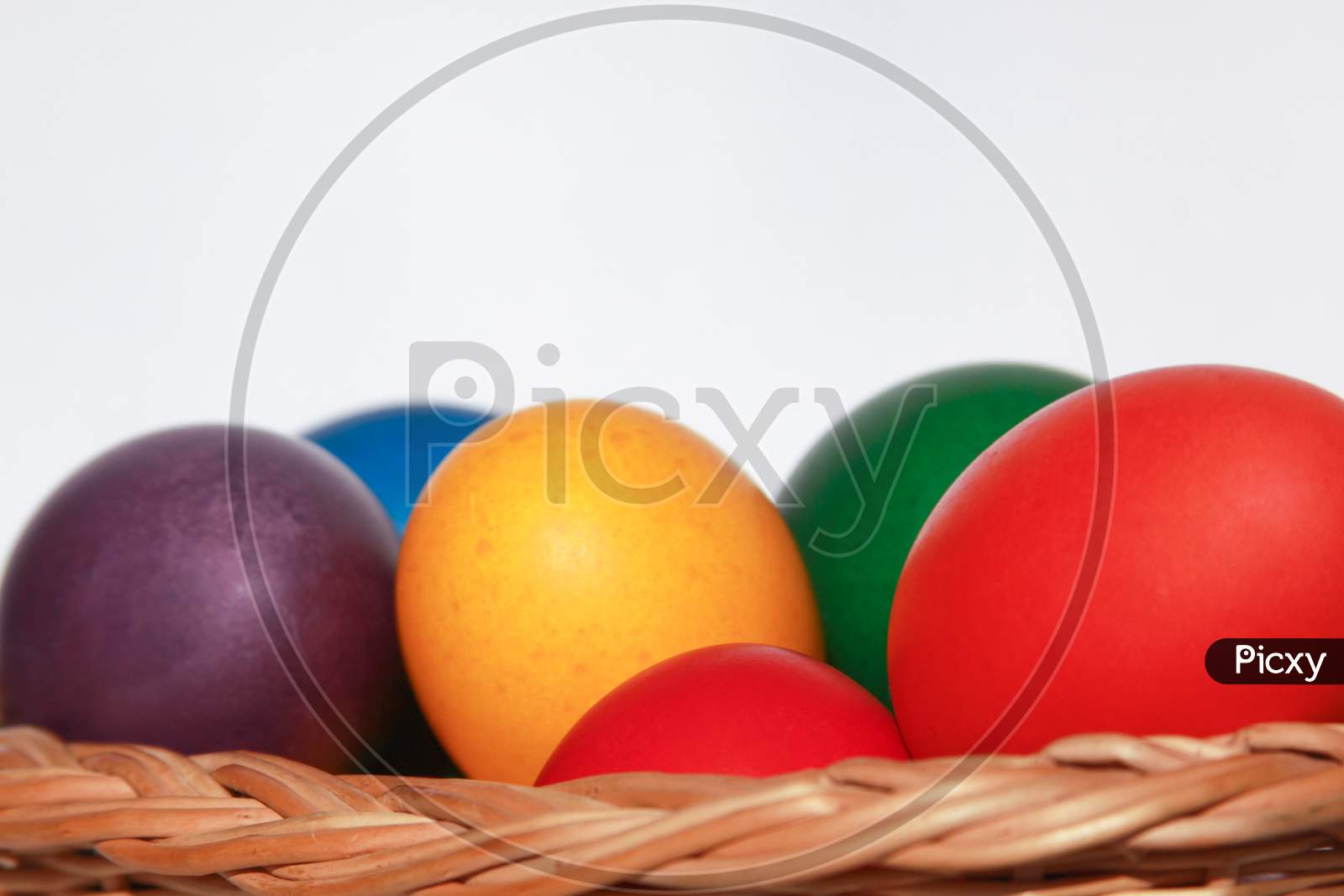 Easter Eggs Colors In Basket White Background