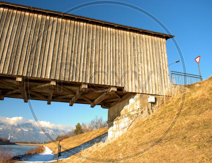 Wooden Old Bridge Across The Rhine River In Vaduz In Liechtenstein 7.1.2021