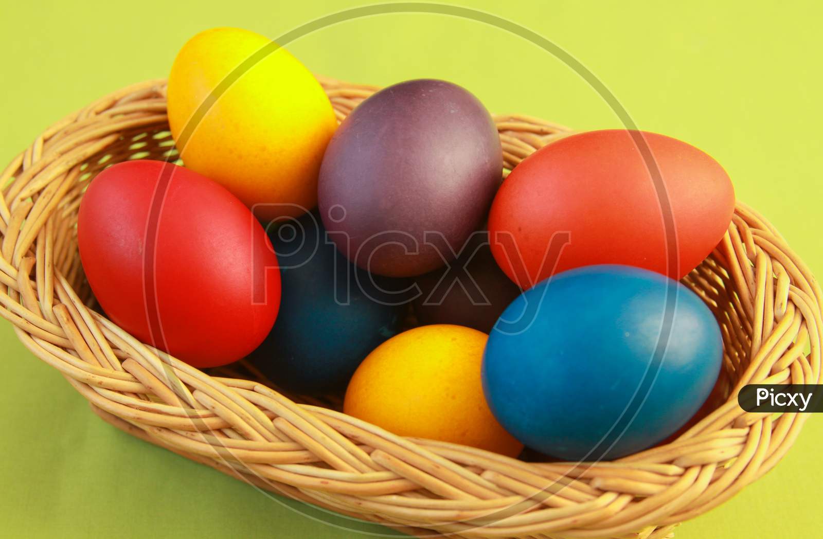 Easter Eggs Colors In Basket Green Background