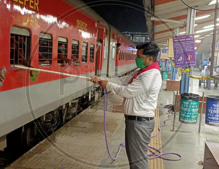 Corona warriors watering people on a train during the Corona epidemic