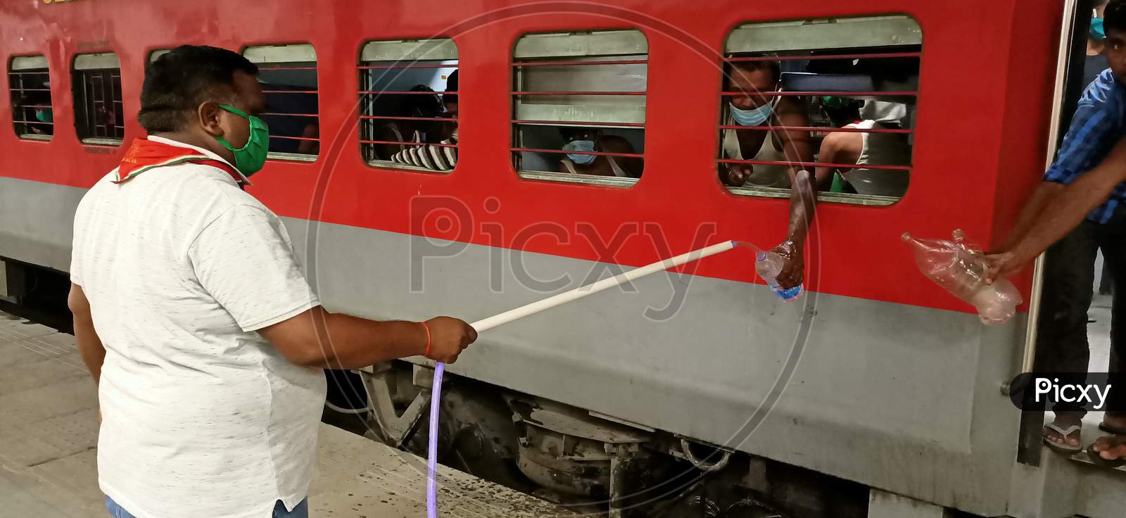 Corona warriors watering people on a train during the Corona epidemic