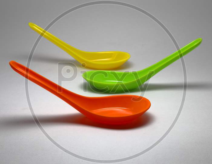 Colorful Spoons Isolated On A White Background