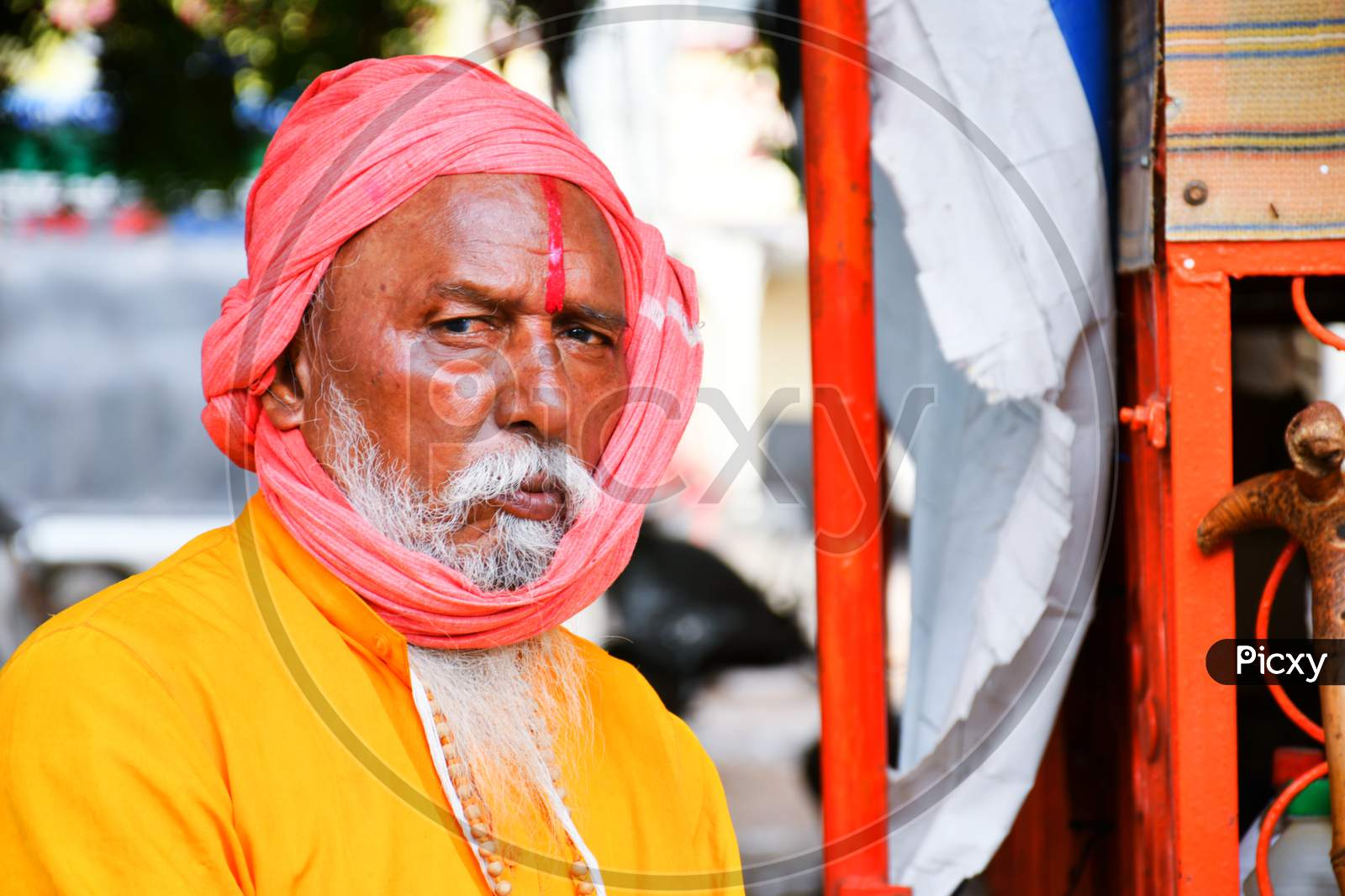 Indian Monk wear orange cloths and looking front